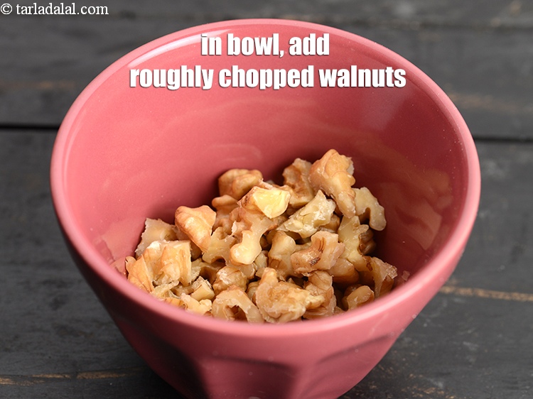 Step 7 – In another bowl, add &frac12; cup roughly <a href="https://www.tarladalal.com/glossary-chopped-walnuts-785i">chopped walnuts (akhrot)</a>.
