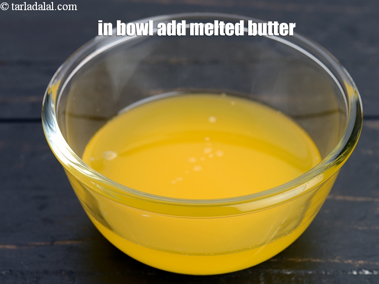 Step 7 – In another bowl add &frac14; cup <a href="https://www.tarladalal.com/glossary-melted-butter-1941i">melted butter</a>.