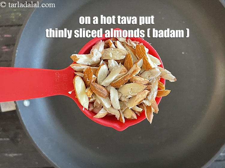 Step 7 – On a hot tava put&nbsp;<meta charset="UTF-8" />1/4 cup&nbsp;<a href="glossary-almond-slivers-slivered-almonds-664i">thinly sliced almonds (badam)</a>.