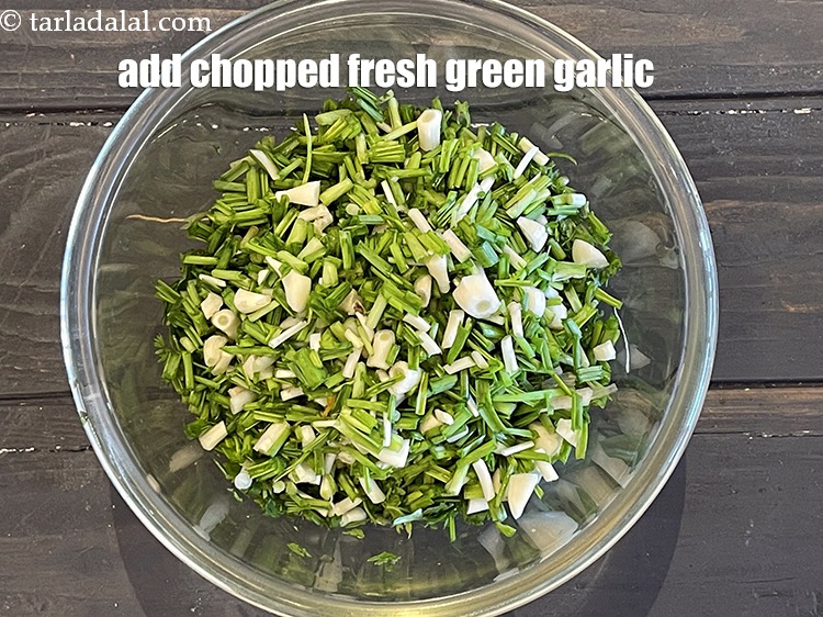 Step 12 – Add&nbsp;<meta charset="UTF-8" />1/2 cup&nbsp;<a href="glossary-chopped-green-garlic-849i">chopped fresh green garlic (hara lehsun)</a>&nbsp;, (including the greens).