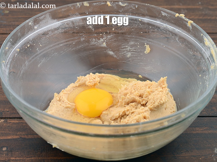 Step 7 – Add 1&nbsp;<a href="https://www.tarladalal.com/glossary-eggs-398i">egg</a>.