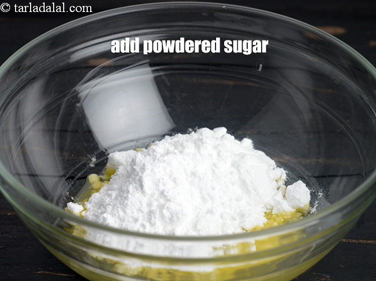 Step 7 – Add &frac12; cup <a href="https://www.tarladalal.com/glossary-powdered-sugar-280i">powdered sugar</a>.