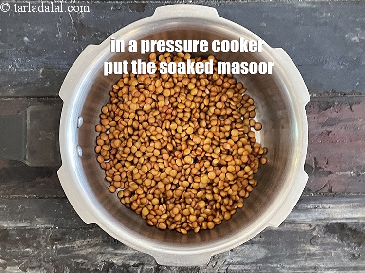 Step 15 – In a pressure cooker put soaked&nbsp;<meta charset="UTF-8" />1/2 cup&nbsp;<a href="glossary-masoor-whole-red-lentil-kala-masoor-301i">masoor (whole red lentil)</a>.