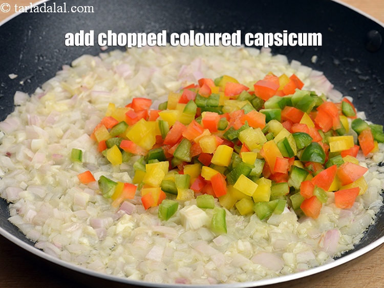 Step 10 – Add &frac12; cup <a href="https://www.tarladalal.com/glossary-chopped-coloured-capsicum-2800i">chopped coloured capsicum</a>.