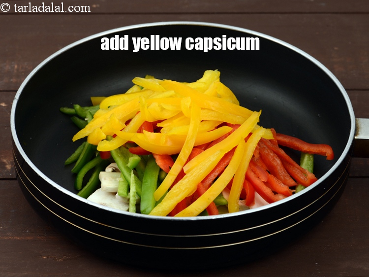 Step 15 – Add 1/2 cup&nbsp;<a href="https://www.tarladalal.com/glossary-sliced-yellow-capsicum-2178i">sliced yellow capsicum</a>.
