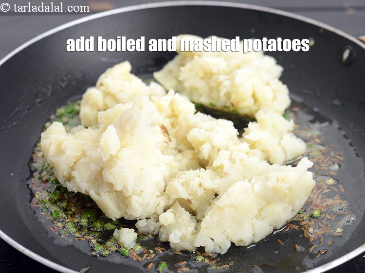 Step 8 – Add 1 cup <a href="https://www.tarladalal.com/glossary-boiled-and-mashed-potatoes-1831i">boiled , peeled and mashed potatoes</a>.