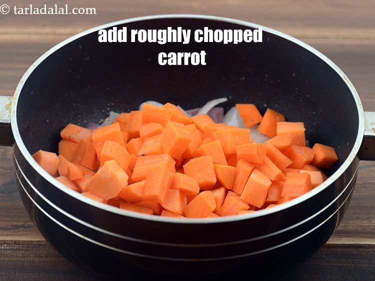 Step 7 – Add 1&frac12; cups roughly <a href="https://www.tarladalal.com/glossary-chopped-carrot-798i">chopped carrot</a>.