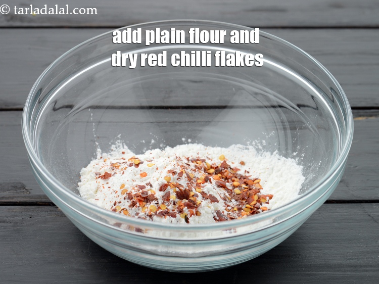 Step 7 – Add 2 tbsp&nbsp;<a href="https://www.tarladalal.com/glossary-plain-flour-maida-188i">plain flour (maida)</a>&nbsp;and 2 tsp&nbsp;<a href="https://www.tarladalal.com/glossary-dry-red-chilli-flakes-paprika-338i">dry red chilli flakes (paprika)</a>.&nbsp;