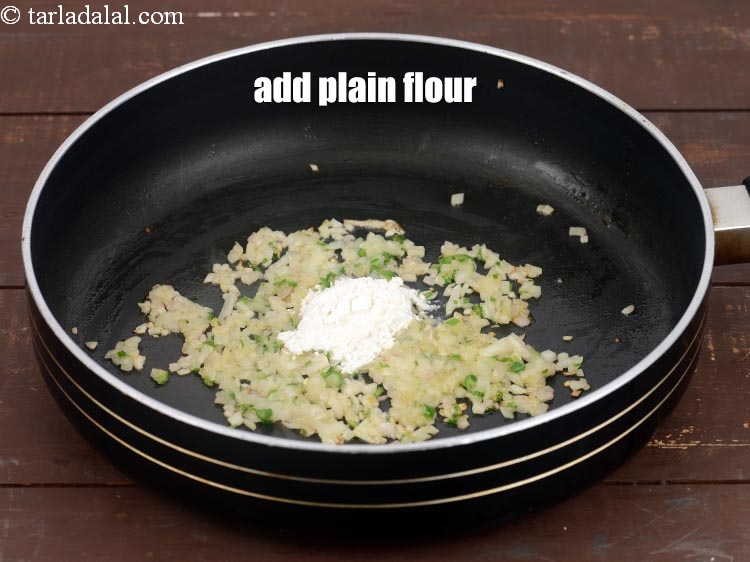Step 7 – Add 1 tsp <a href="https://www.tarladalal.com/glossary-plain-flour-maida-188i">plain flour (maida)</a>.