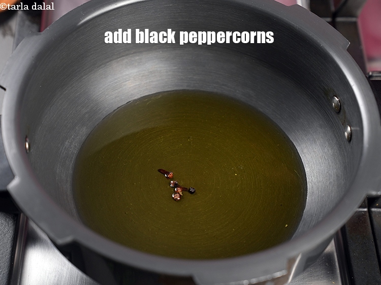 Step 8 – Add 4 <a href="https://www.tarladalal.com/glossary-black-peppercorns-kali-mirch-kalimirch-566i">black peppercorns (kalimirch)</a>.