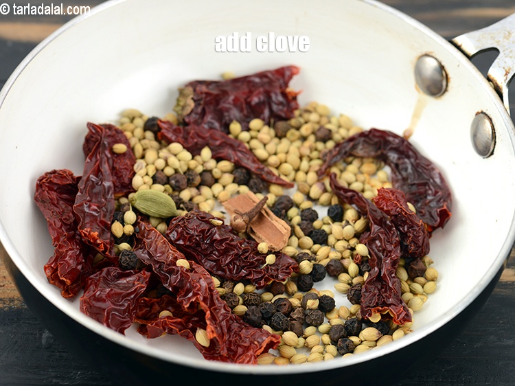 Step 9 – Add 1 <a href="https://www.tarladalal.com/glossary-cloves-laung-lavang-322i">clove (laung / lavang)</a>.