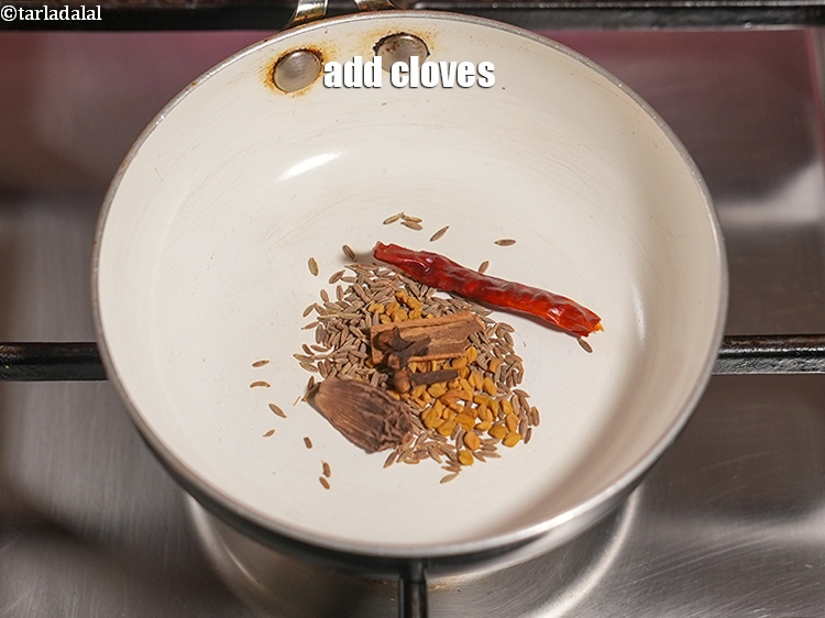 Step 8 – Add 3 <a href="https://www.tarladalal.com/glossary-cloves-laung-lavang-322i">cloves (laung / lavang)</a>.
