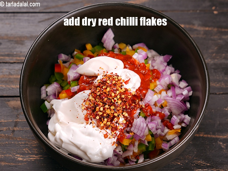 Step 9 – Add 1 tsp&nbsp;<a href="https://www.tarladalal.com/glossary-dry-red-chilli-flakes-paprika-338i">dry red chilli flakes (paprika)</a>.&nbsp;