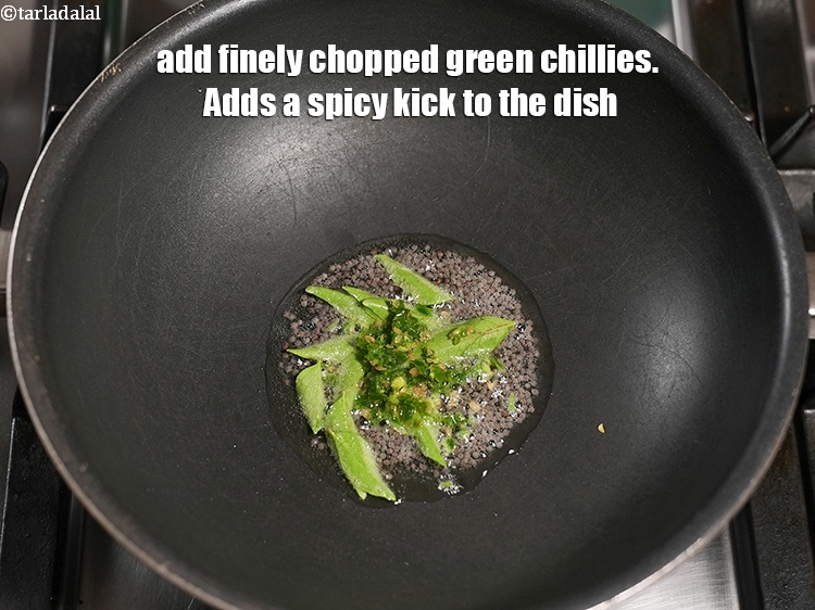 Step 11 – Add 1 tsp finely <a href="https://www.tarladalal.com/glossary-chopped-green-chilli-820i">chopped green chillies</a>. Adds a spicy kick to the dish.