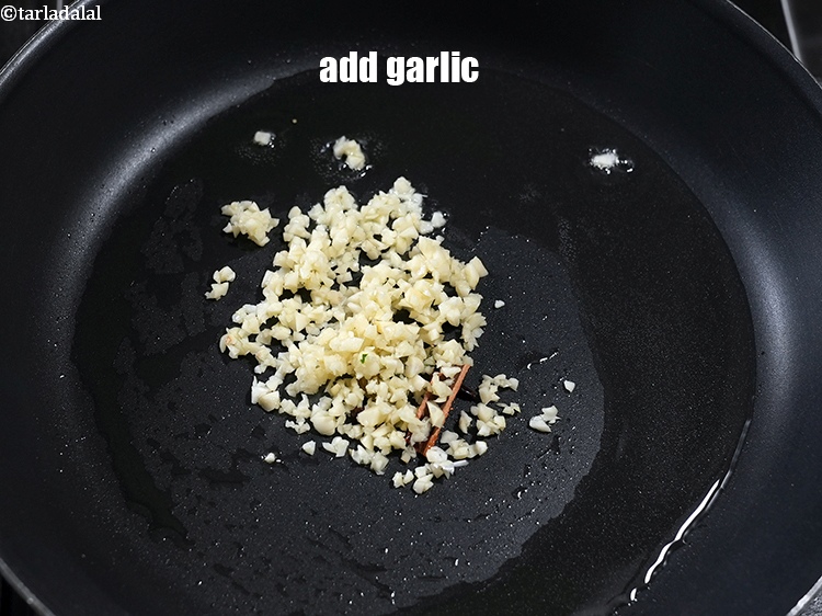 Step 12 – Add 2 tbsp finely <a href="https://www.tarladalal.com/glossary-chopped-garlic-790i">chopped garlic (lehsun)</a>.