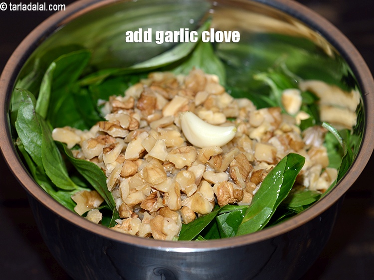 Step 8 – Add 1 <a href="https://www.tarladalal.com/glossary-garlic-cloves-1857i">garlic (lehsun) clove</a>.