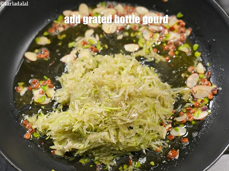Step 8 – Add 1&frac12; cups <a href="https://www.tarladalal.com/glossary-grated-bottle-gourd-1048i">grated bottle gourd (doodhi / lauki)</a>.