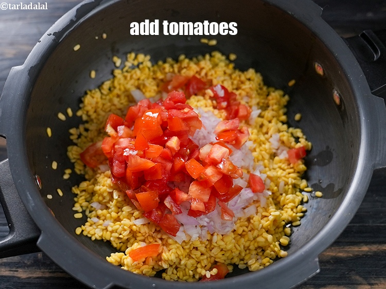 Step 8 – Add &frac12; cup <a href="https://www.tarladalal.com/glossary-chopped-tomatoes-779i">chopped tomatoes</a>.