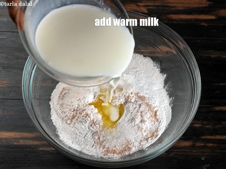 Step 8 – Add 2&frac34; cups warm <a href="https://www.tarladalal.com/glossary-milk-doodh-full-cream-milk-514i">milk</a>.