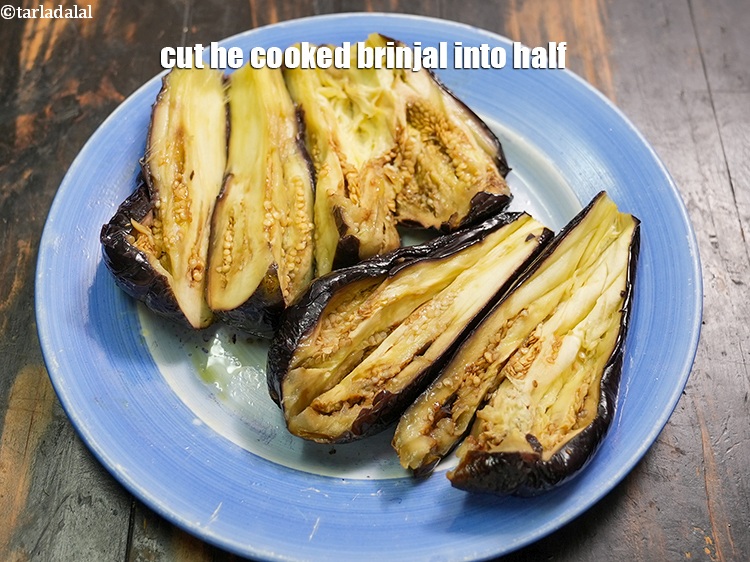 Step 8 – Cut he cooked brinjal into half.