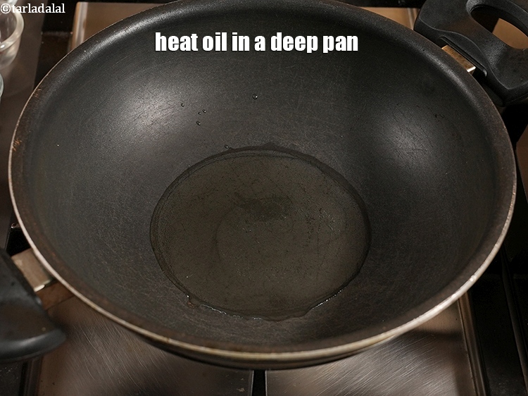 Step 8 – Heat 2 tbsp <a href="https://www.tarladalal.com/glossary-oil-671i">oil</a> in a deep pan.
