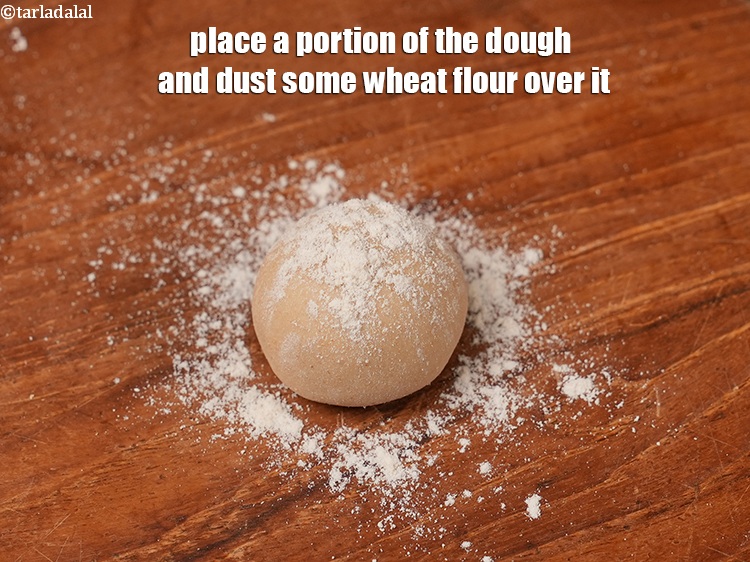 Step 11 – Place a portion of the dough and dust some wheat flour over it.