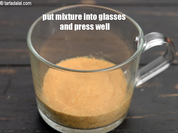 Step 8 – Put half the biscuit-butter mixture into 2 glasses and press it well. Keep aside.&nbsp;