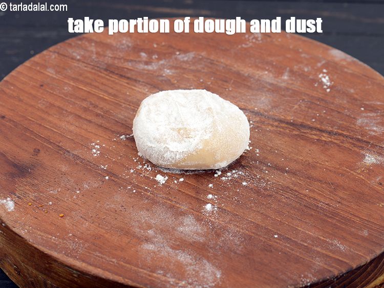 Step 8 – Take a portion of the dough and dust with wheat flour.