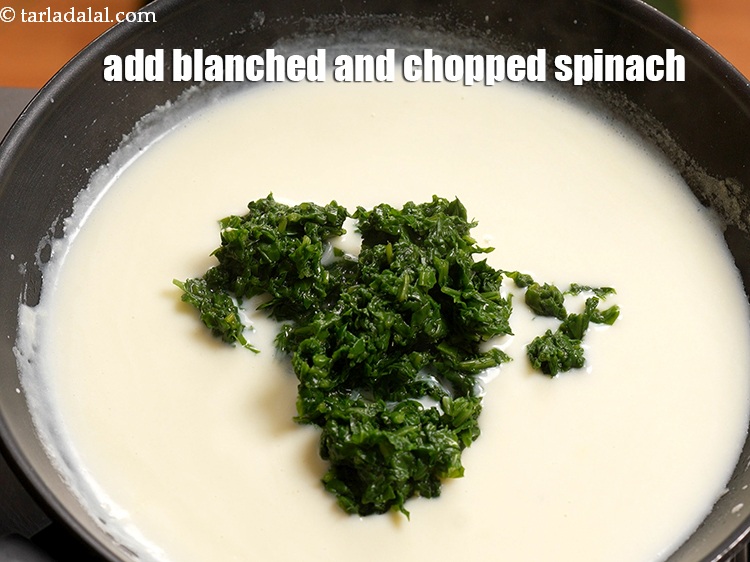 Step 8 – Add &frac12; cup <a href="https://www.tarladalal.com/glossary-blanched-and-chopped-spinach-1915i">blanched and finely chopped spinach</a>.