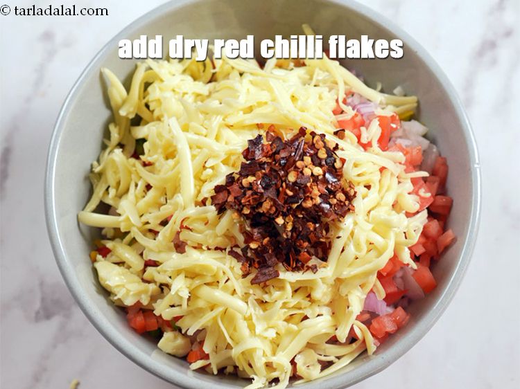 Step 9 – Add 2 tsp <a href="https://www.tarladalal.com/glossary-dry-red-chilli-flakes-paprika-338i">dry red chilli flakes (paprika)</a>.