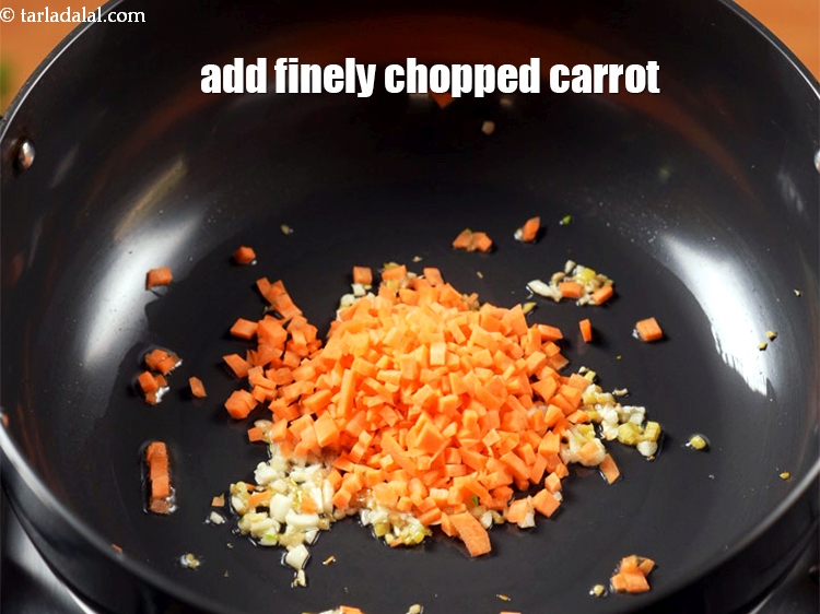 Step 12 – Add &frac14; cup finely <a href="https://www.tarladalal.com/glossary-chopped-carrot-798i">chopped carrot</a>.