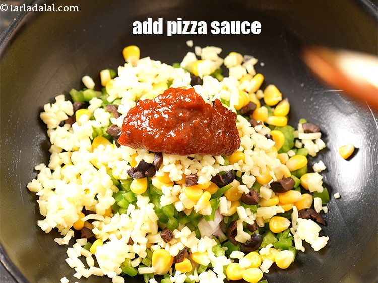 Step 8 – Add 2 tbsp <a href="https://www.tarladalal.com/glossary-pizza-sauce-1889i">pizza sauce</a>.
