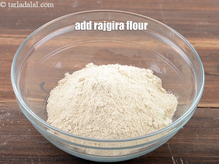 Step 8 – Add &frac12; cup<a href="https://www.tarladalal.com/glossary-rajgira-flour-ramadana-flour-amaranth-flour-rajgira-ka-atta-1297i"> rajgira (amaranth) flour</a>.