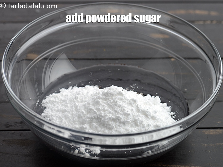 Step 8 – Add &frac12; cup <a href="https://www.tarladalal.com/glossary-powdered-sugar-280i">powdered sugar</a>.