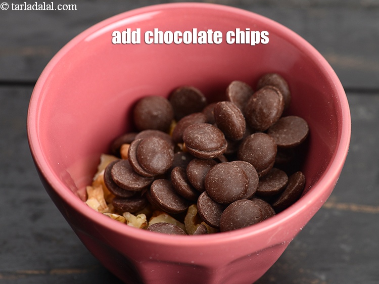 Step 8 – Add &frac14; cup <a href="https://www.tarladalal.com/glossary-chocolate-chips-325i">chocolate chips</a>.