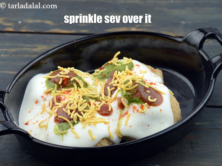 Step 68 – Sprinkle 1 tbsp <a href="https://www.tarladalal.com/glossary-sev-1137i">sev</a>&nbsp;evenly over it.