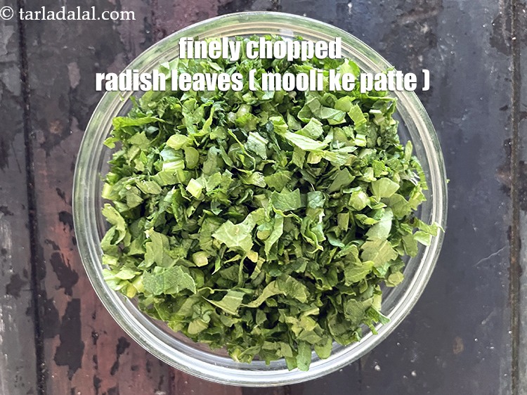 Step 13 – Put finely chopped radish leaves in a bowl.