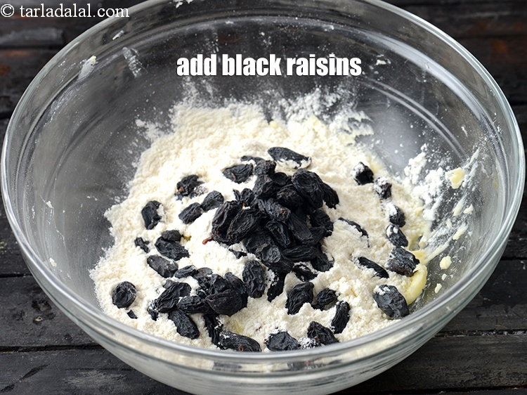 Step 8 – Add &frac14; cup <a href="https://www.tarladalal.com/glossary-black-raisins-kali-kismis-kali-kishmish-600i">black raisins</a>&nbsp;.