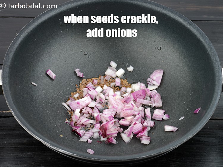Step 8 – When the seeds crackle, add 1/4 cup&nbsp;<a href="https://www.tarladalal.com/glossary-chopped-onions-722i">chopped onions</a>.&nbsp;