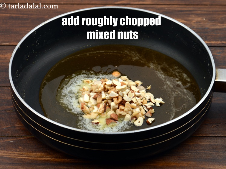 Step 8 – Add &frac14; cup roughly <a href="https://www.tarladalal.com/glossary-chopped-mixed-nuts-928i">chopped mixed nuts</a> (cashews, almonds, walnuts).