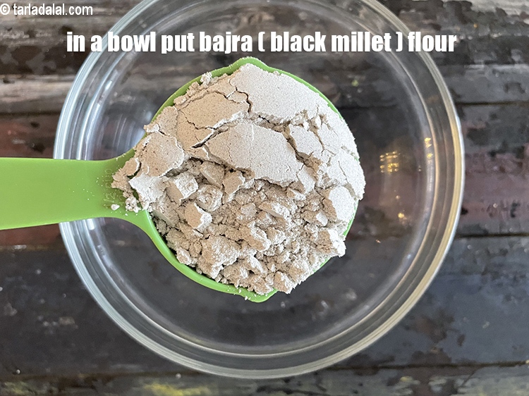 Step 8 – In a bowl put&nbsp;<meta charset="UTF-8" />1/2 cup&nbsp;<a href="glossary-bajra-flour-bajra-ka-atta-bajre-ka-atta-176i">bajra (black millet) flour</a>.