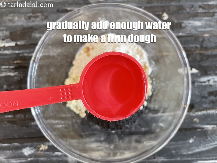 Step 8 – Gradullay add enough water to make a firm dough. We added 3 tablespoons water.