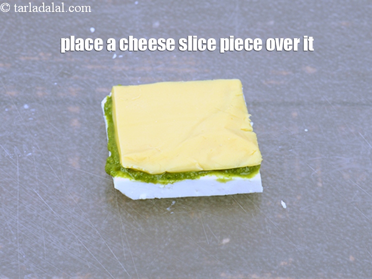 Step 19 – Place a cheese slice piece over it. Ensure that the paneer slice is bigger than …