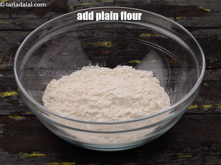 Step 10 – Add the <a href="https://www.tarladalal.com/glossary-plain-flour-maida-188i" target="_blank">plain flour</a>, this is our main ingredient. Make sure the plain …
