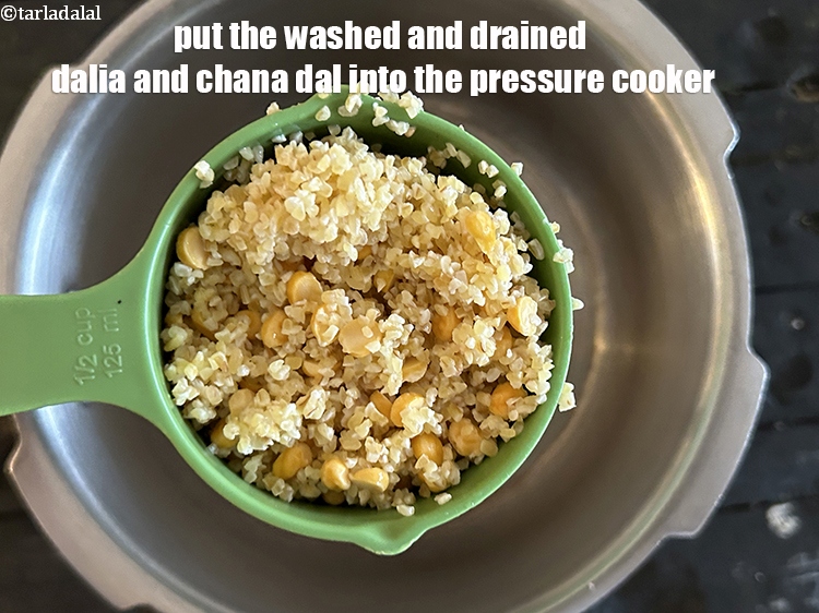 Step 9 – Put the washed and drained dalia and chana dal into the pressure cooker.