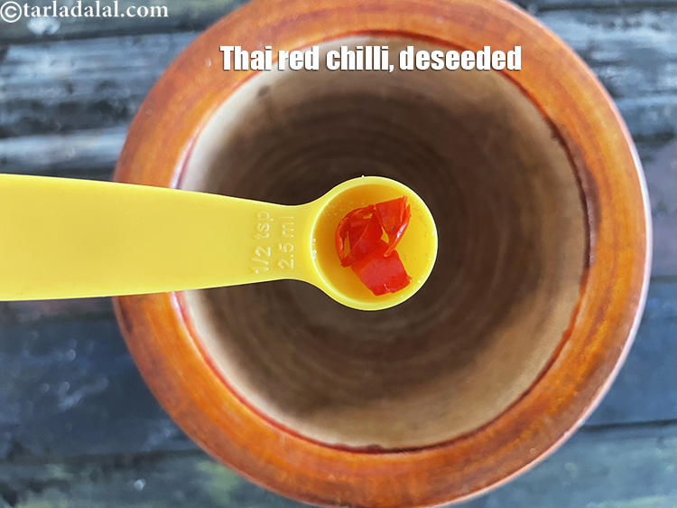 Step 23 – In a mortar, put&nbsp;<meta charset="UTF-8" />1 Thai&nbsp;<a href="glossary-fresh-red-chillies-lal-mirch-lal-mirchi-334i">red chilli</a>&nbsp;, deseeded and cut in segments.