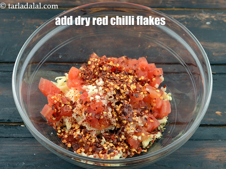 Step 8 – Add 1 tbsp&nbsp;<a href="https://www.tarladalal.com/glossary-dry-red-chilli-flakes-paprika-338i">dry red chilli flakes (paprika)</a>.&nbsp;