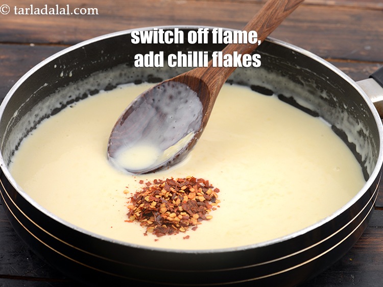 Step 8 – Switch off the flame, add 2 tsp&nbsp;<a href="https://www.tarladalal.com/glossary-dry-red-chilli-flakes-paprika-338i">dry red chilli flakes</a>.&nbsp;