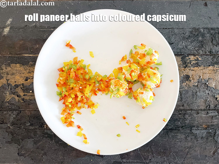 Step 14 – Roll the paneer balls into the coloured capsicum. You have to be a bit patient …