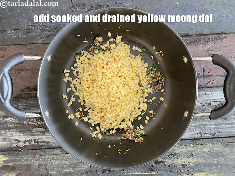 Step 20 – Add&nbsp;<meta charset="UTF-8" />1/2 cup soaked and drained&nbsp;<a href="glossary-yellow-moong-dal-split-yellow-gram-peeli-moong-dal-488i">yellow moong dal (split yellow gram)</a>.